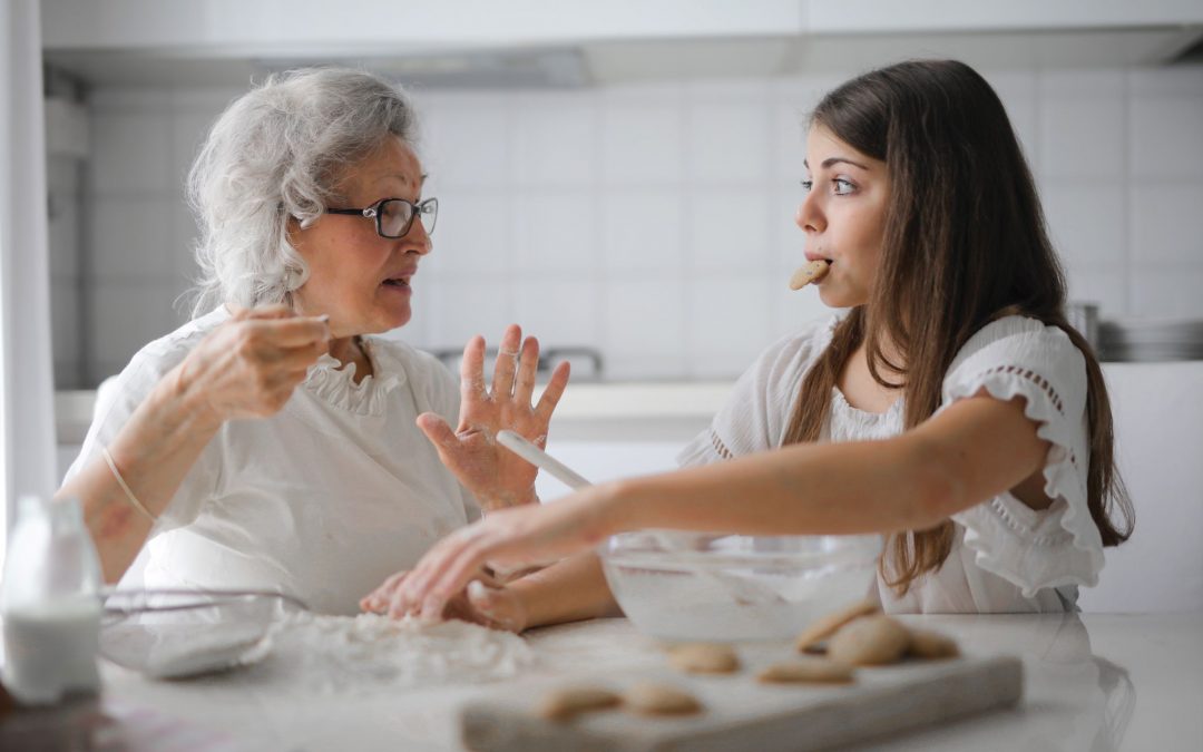 healthy senior grandmother elderly woman baking with young granddaughter girl