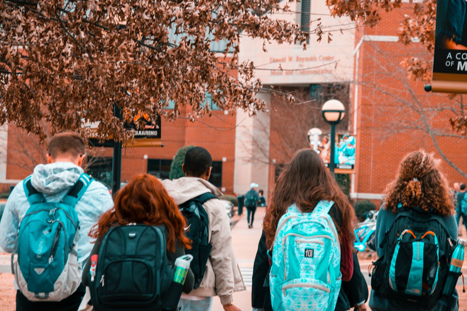 college students with backpacks on campus in the fall tuition scholarships grants loans paying for college financial advisor paramount wealth management